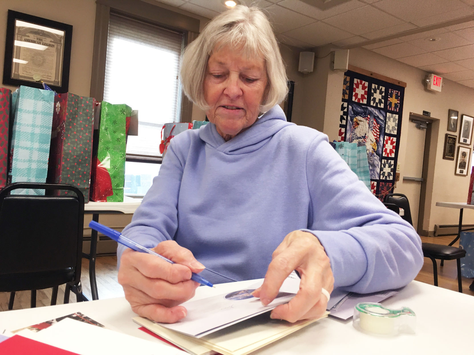 Carol Amborn addresses envelopes for holiday gifts to veterans home